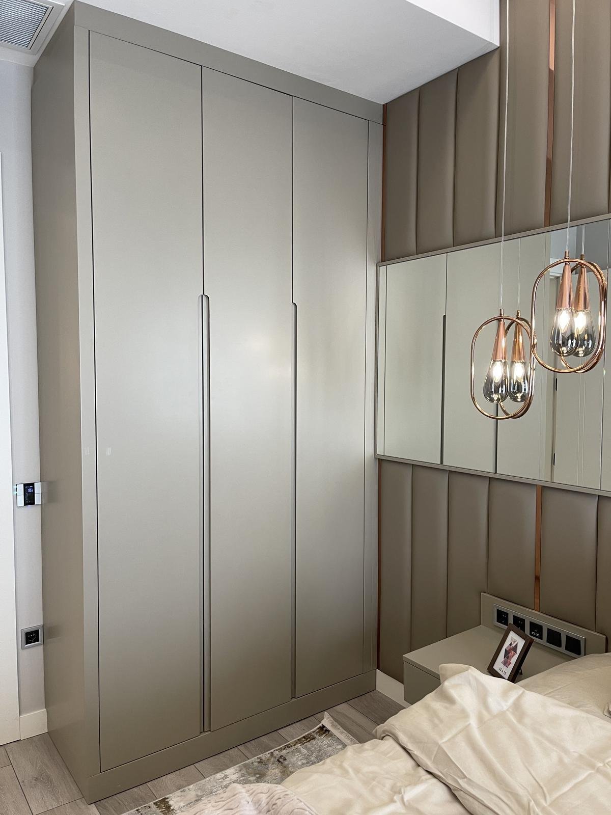 Master bedroom with full-height wardrobe wall and mirror panels